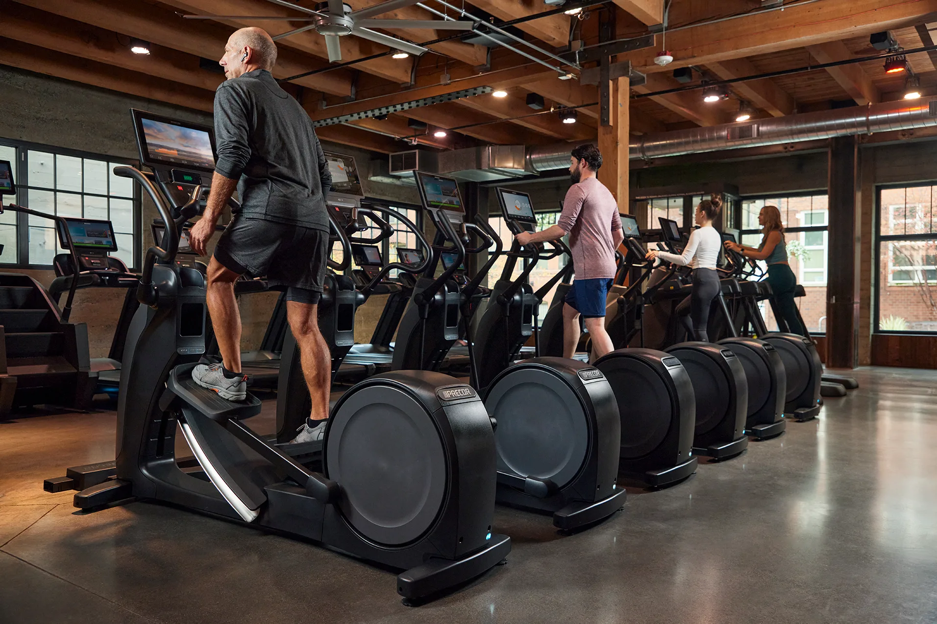 Precor_Facility_Row_of_EFX_with_People_plus_other_Precor_Cardio_with_P94_P84_consoles.jpg